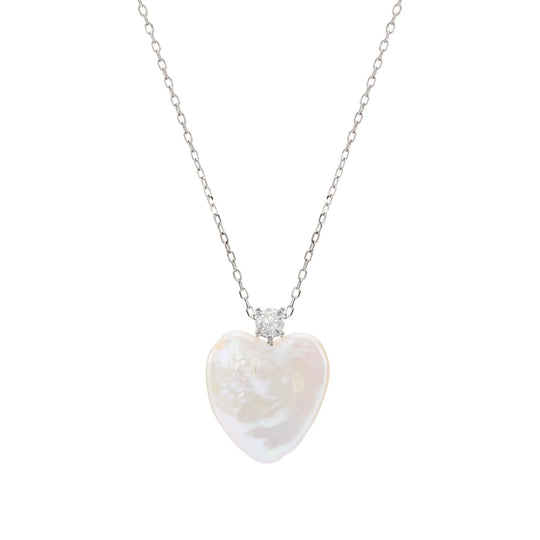 Minimal white background overhead shot of thin sterling silver chain necklace with single heart-shaped baroque pearl focal pendant