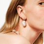 model wearing baroque pearl drop earrings with zircon detail