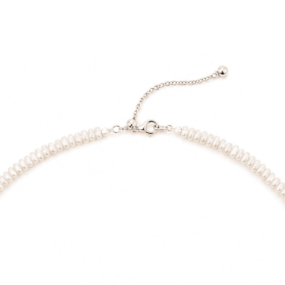 Adjustable silver clasp and extension chain detail of beaded necklace