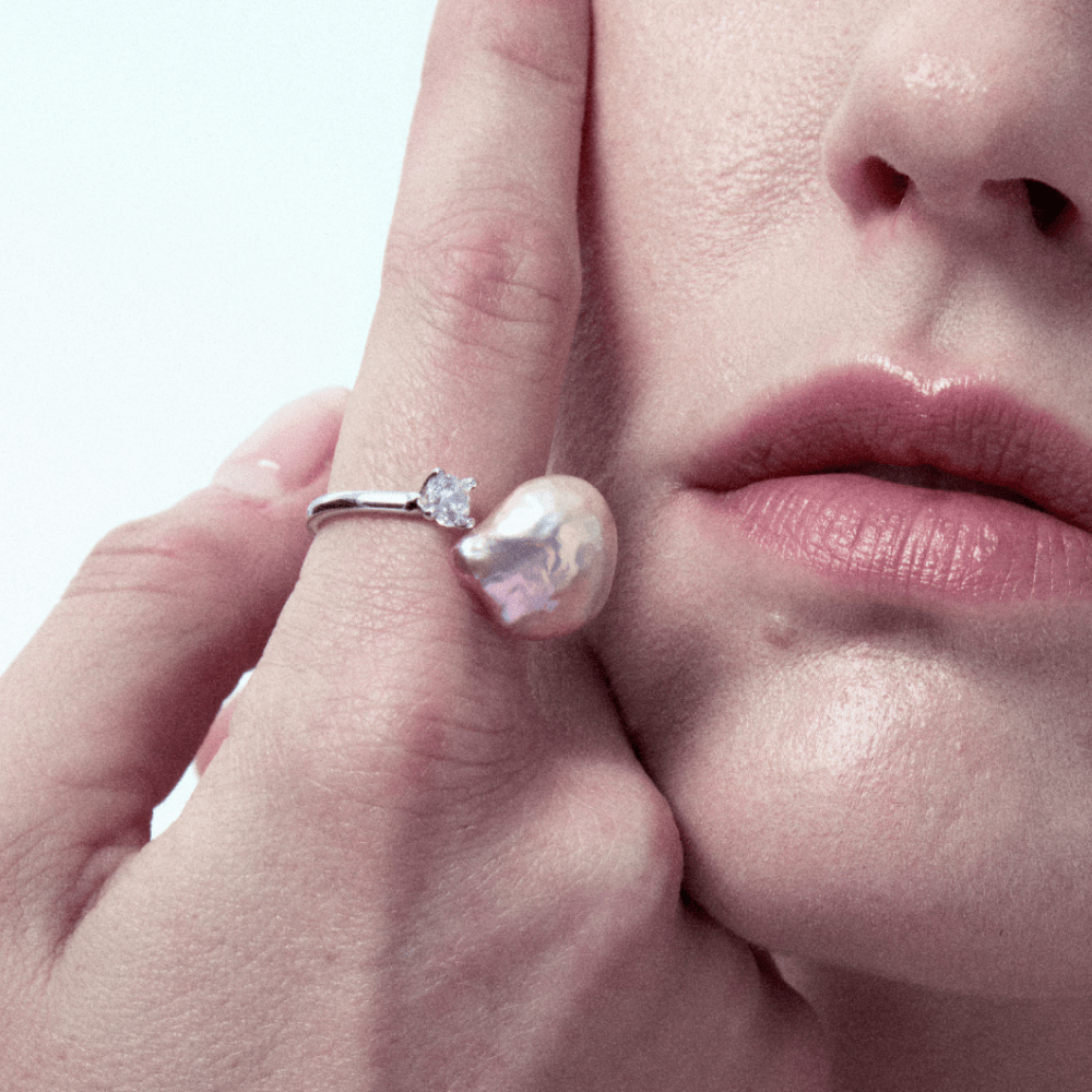 Close-up of model wearing the statement pearl ring on finger
