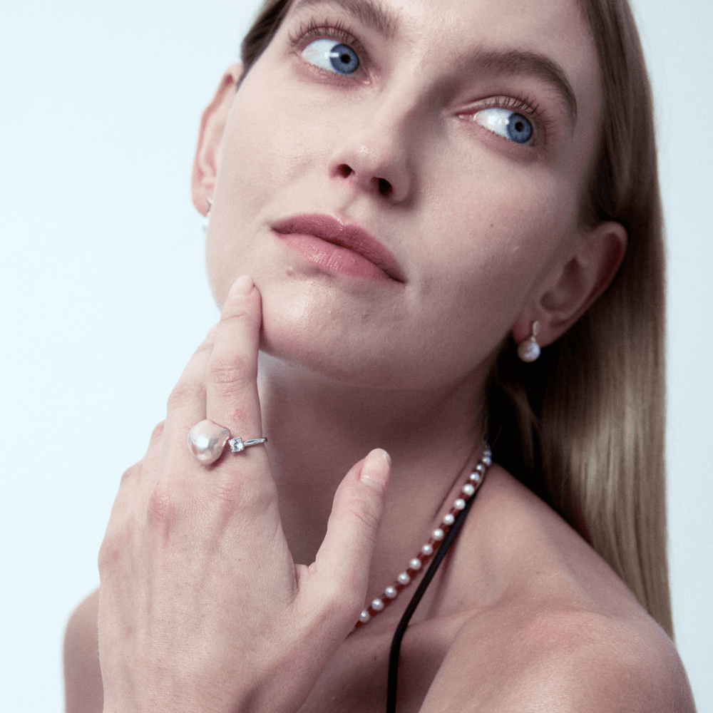 Model styling the pearl ring with matching pearl necklace