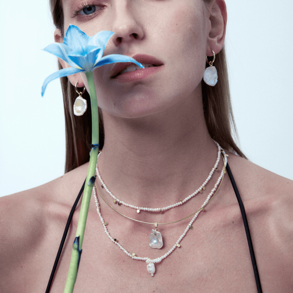 Model wearing Aurora Pearl Baroque Necklace in layered styling