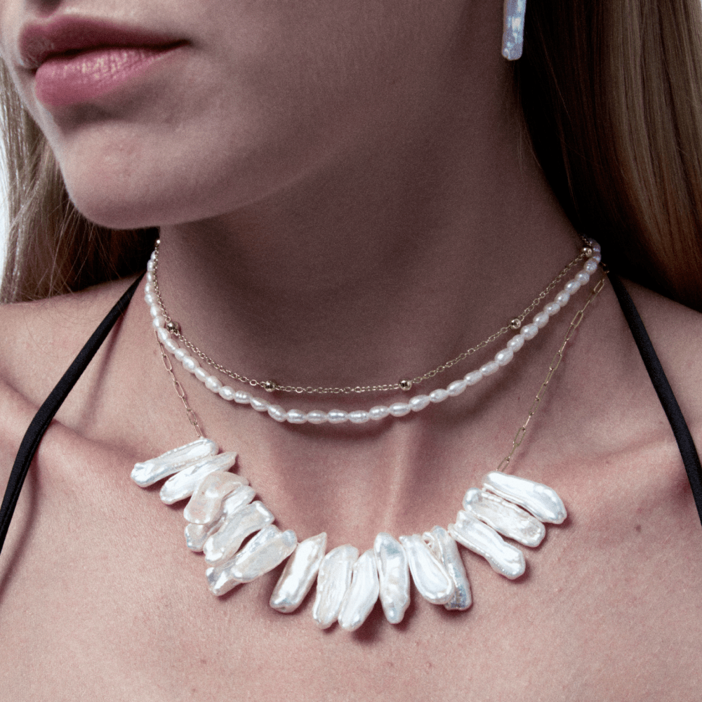 White pearl and gold layered necklaces stacking for everyday wear