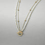 Gold toggle clasp with Roman numerals on freshwater pearl necklace