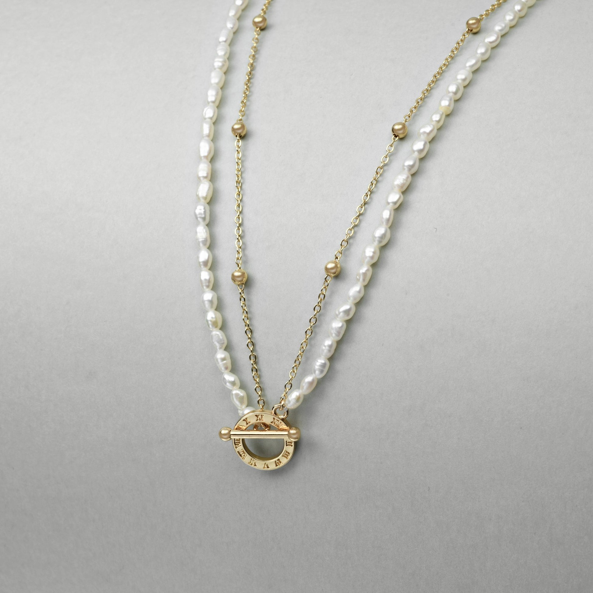 Gold toggle clasp with Roman numerals on freshwater pearl necklace