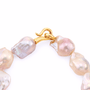 Close-up of 18k gold S-hook clasp on baroque pearl bracelet
