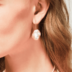 Close-up of large baroque pearl detail on 18k gold-plated prom earrings