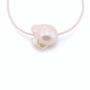Close-up of large baroque pearl detail on pink beaded bracelet