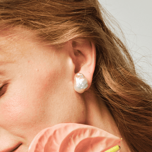 Close-up of large baroque pearl detail on silver stud earring