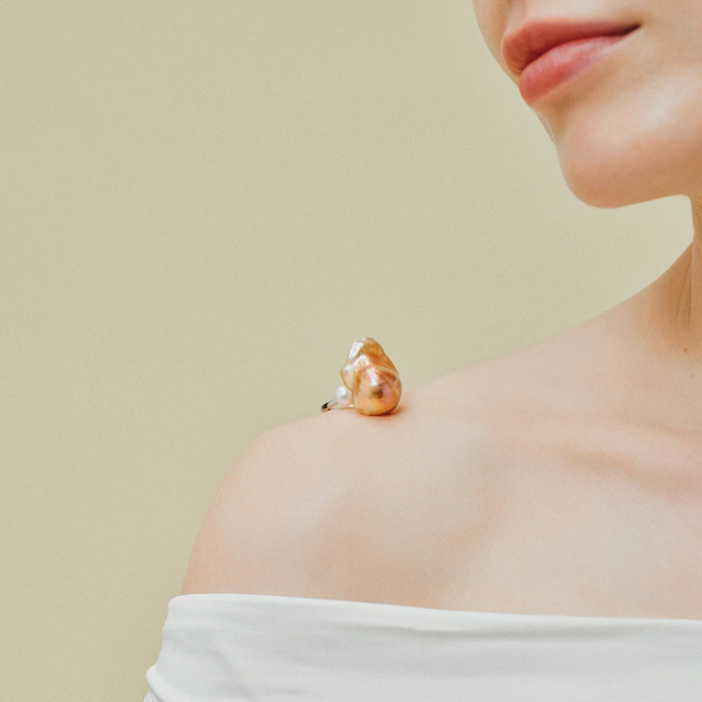 Close up of 20-24mm golden baroque pearl and polished silver open band