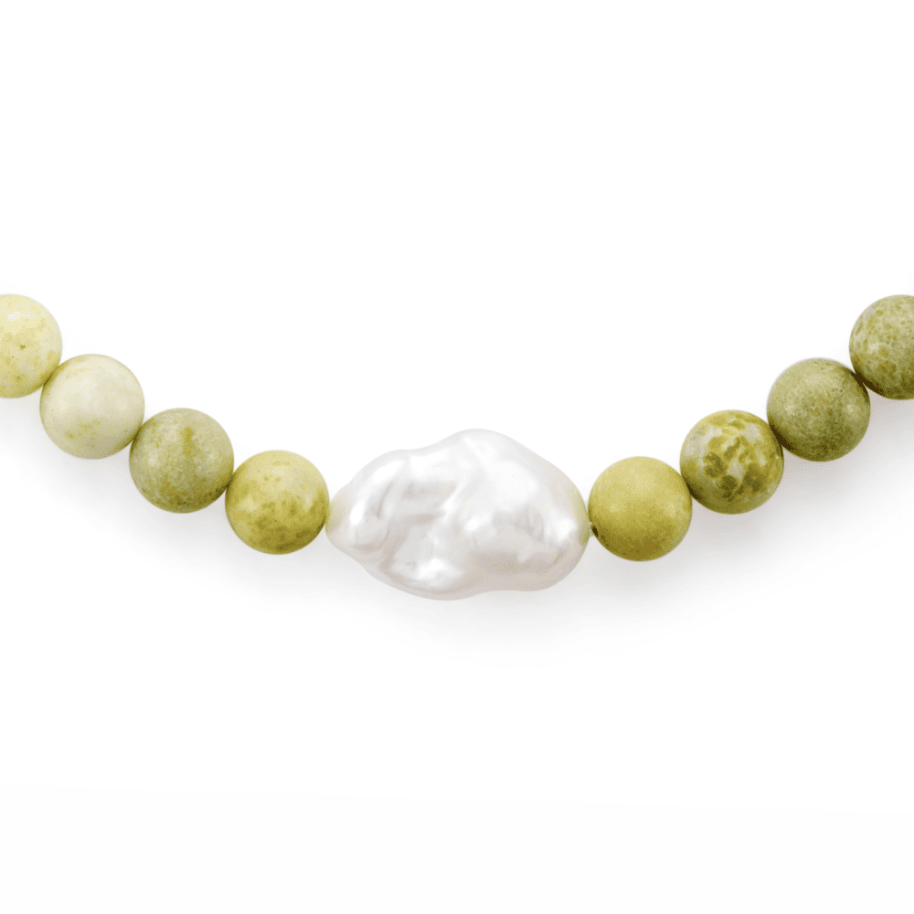 Close up of grand baroque pearl centrepiece and green serpentine beads