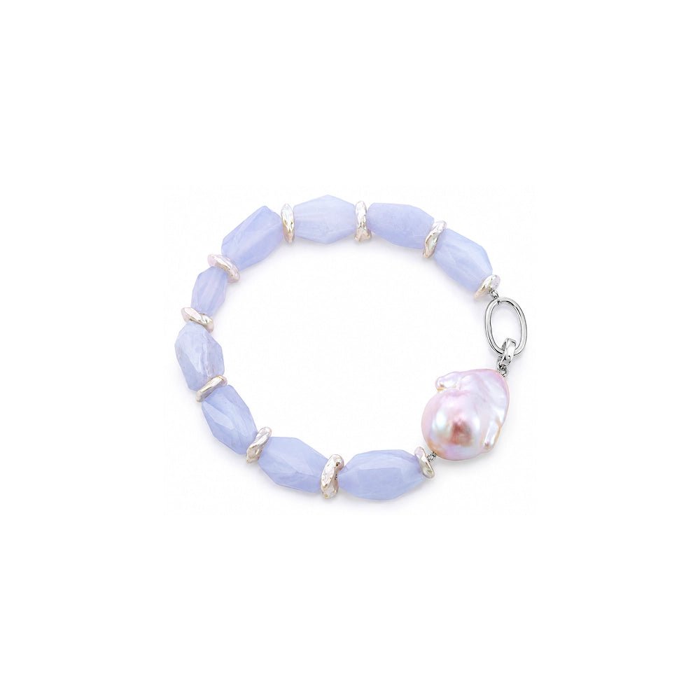 Close up of pink baroque pearl and faceted blue chalcedony beads with silver spacers