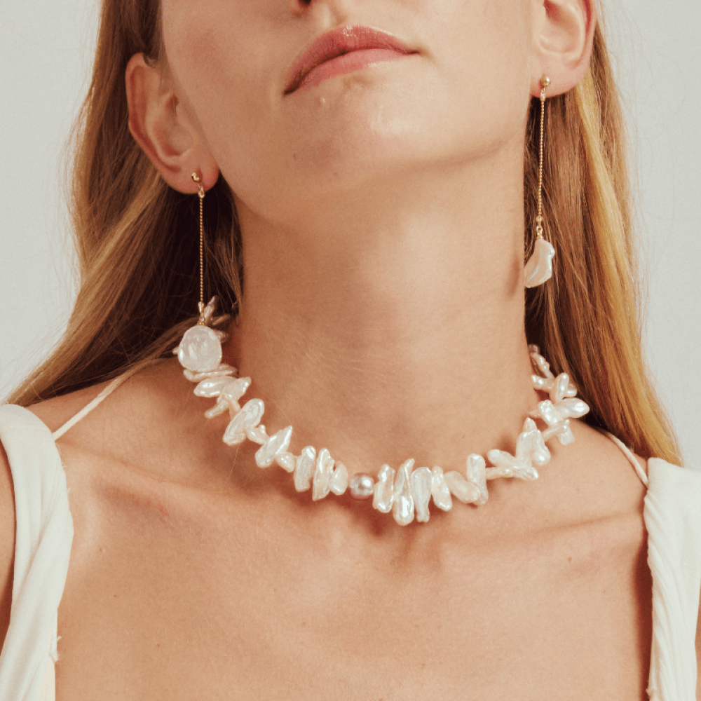 Model wearing the statement pearl choker with white outfit