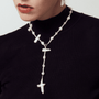 Long adjustable baroque pearl collage necklace with a natural cross pendant.