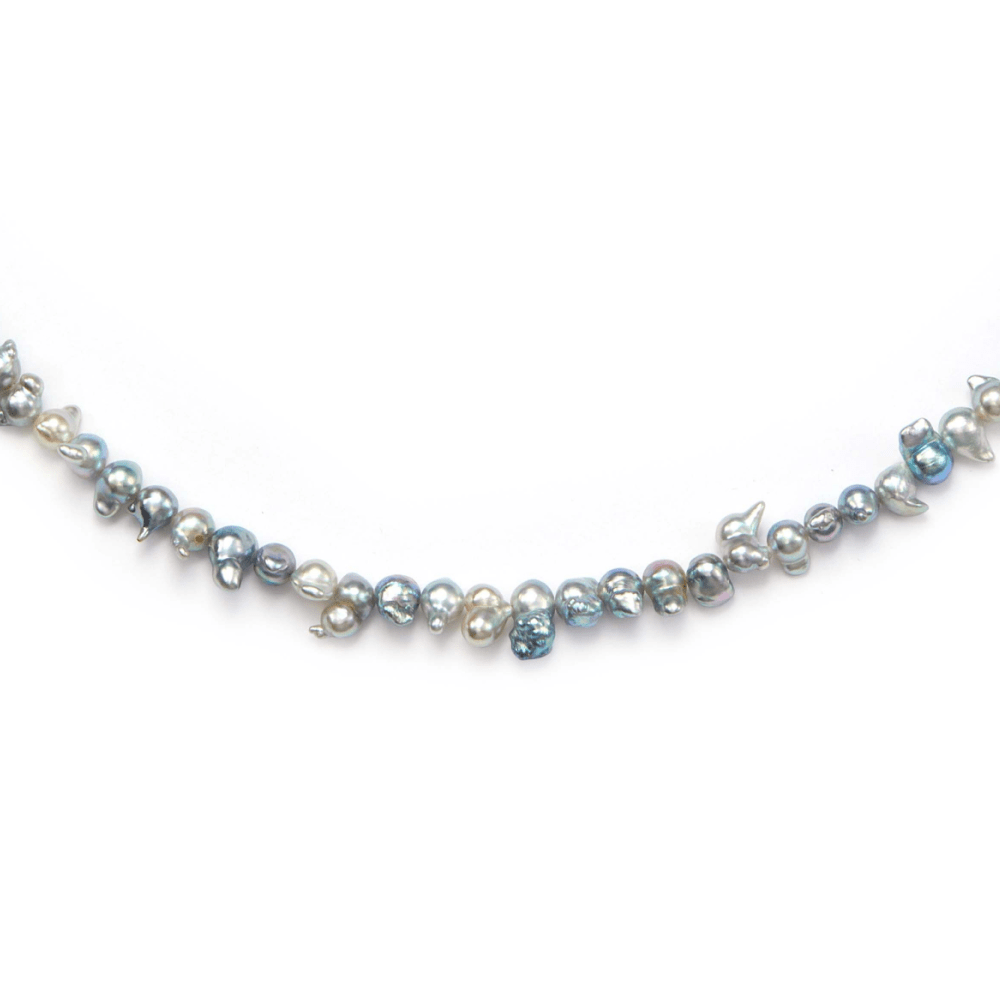 Close-up of blue gray iridescent rainbow luster on keshi baroque pearls