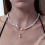 Neutral model wearing the Suno muted gray keshi baroque pearl gold necklace