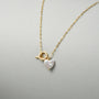 Handmade jewellry gift for Valentine's Day, a freshwater pearl pendant silver necklace with a sculptural heart design.