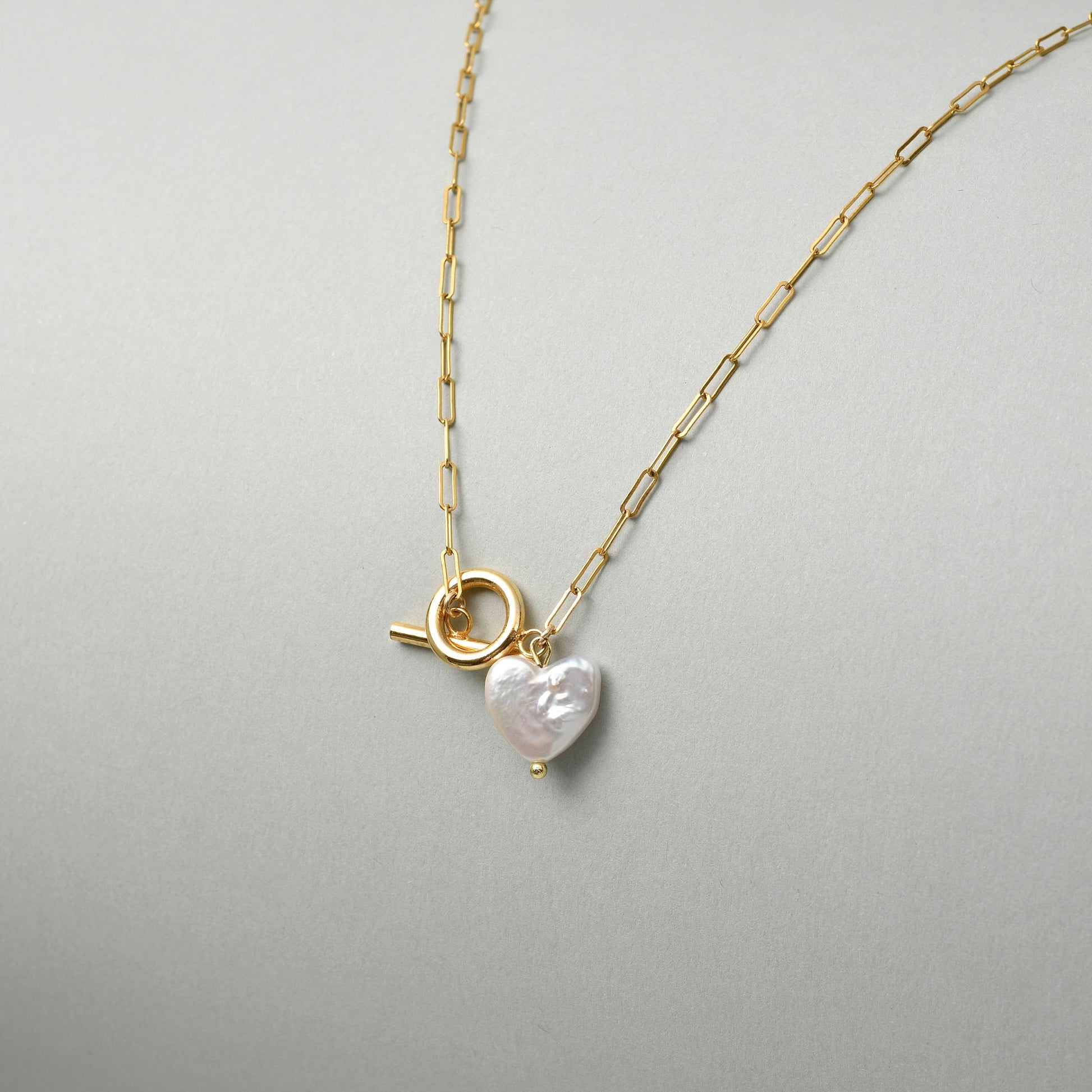 Handmade jewellry gift for Valentine's Day, a freshwater pearl pendant silver necklace with a sculptural heart design.