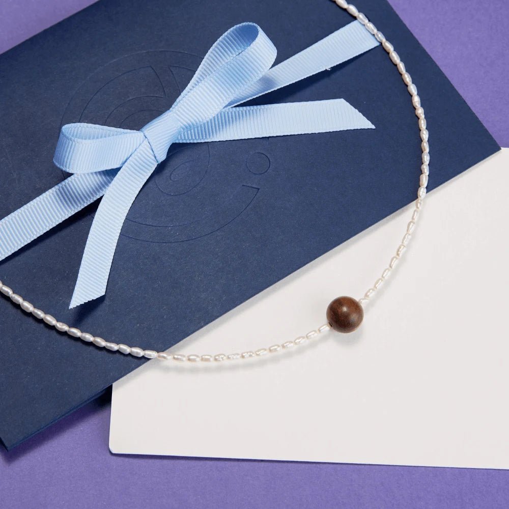 Huali White Mini Keshi Pearl 18k Gold Huali Wood Single Focal Bead Necklace on a gift card