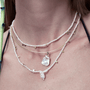 Layered Aurora baroque pearl necklace styled with other necklaces