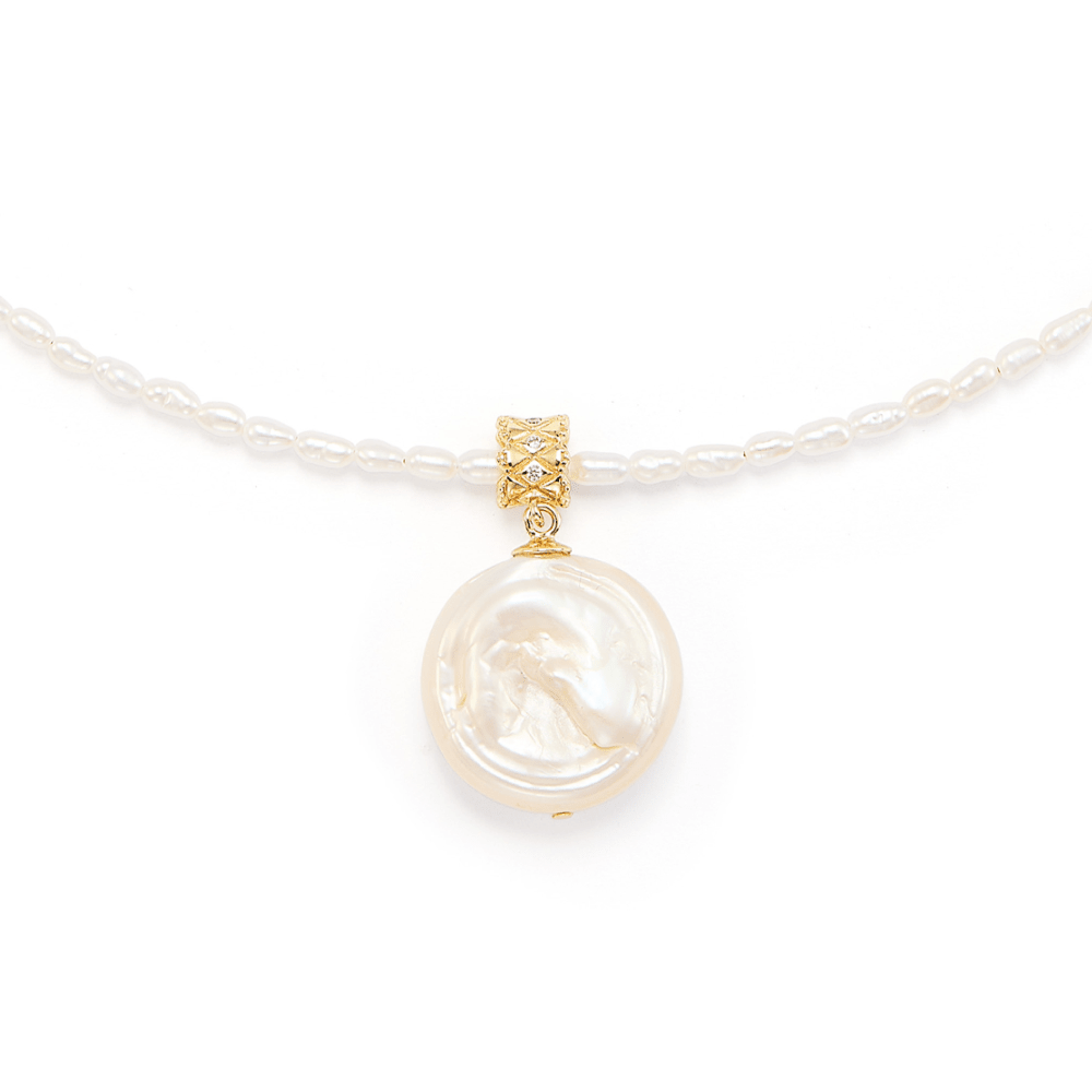Isolated close-up of coin pearl pendant and seed pearl chain