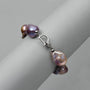 Plain white studio shot showcasing polished anti-tarnish 925 sterling silver safety box clasp attached to purple tidal baroque pearl strand