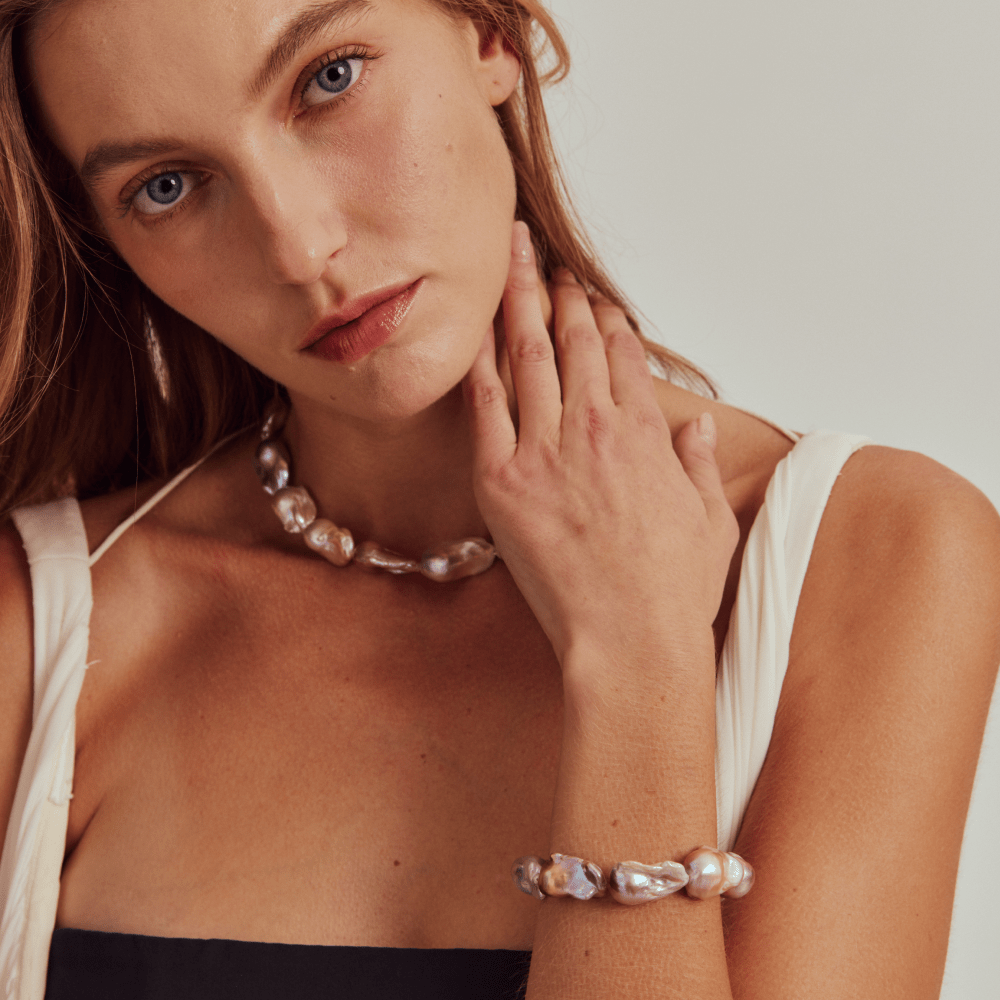 Ethereal view of a model wearing the best quality metallic purple baroque necklace. A perfect staple for daily outfit.
