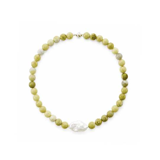 Top-down full overhead studio shot of beaded  necklace, round pale green serpentine stone beads with one large irregular white baroque pearl focal piece and silver spring clasp on plain white background