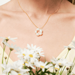 Model wearing baroque pearl flower gold necklace collarbone shot
