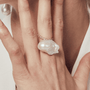 Model wearing the statement pearl ring on hand close-up