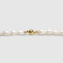 Polished gold clasp close up look on freshwater barouque pearl necklace