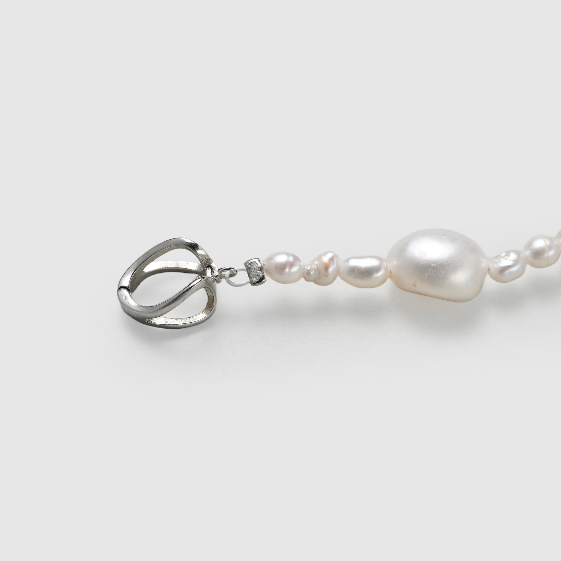 Close-up of the secure sterling silver clasp on a handcrafted unisex pearl cross necklace.