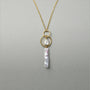Close up vertical stick baroque pearl and teardrop crystal detail