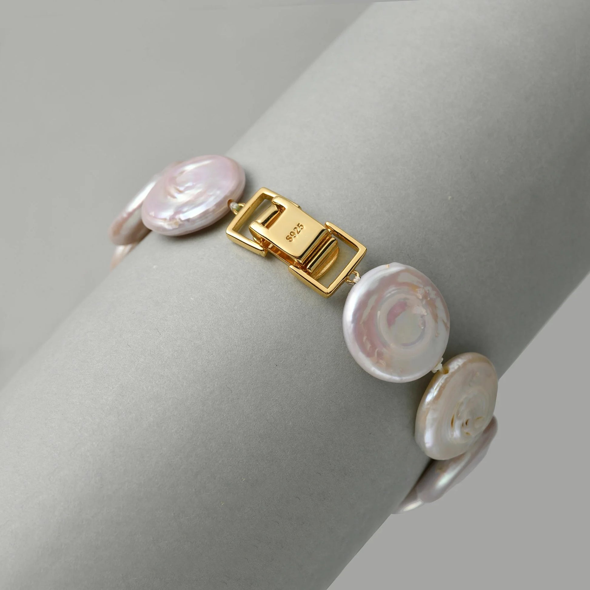 Minimal white studio shot showcasing polished anti-tarnish 18k gold-plated rectangular box clasp attached to white button baroque pearl beaded strand