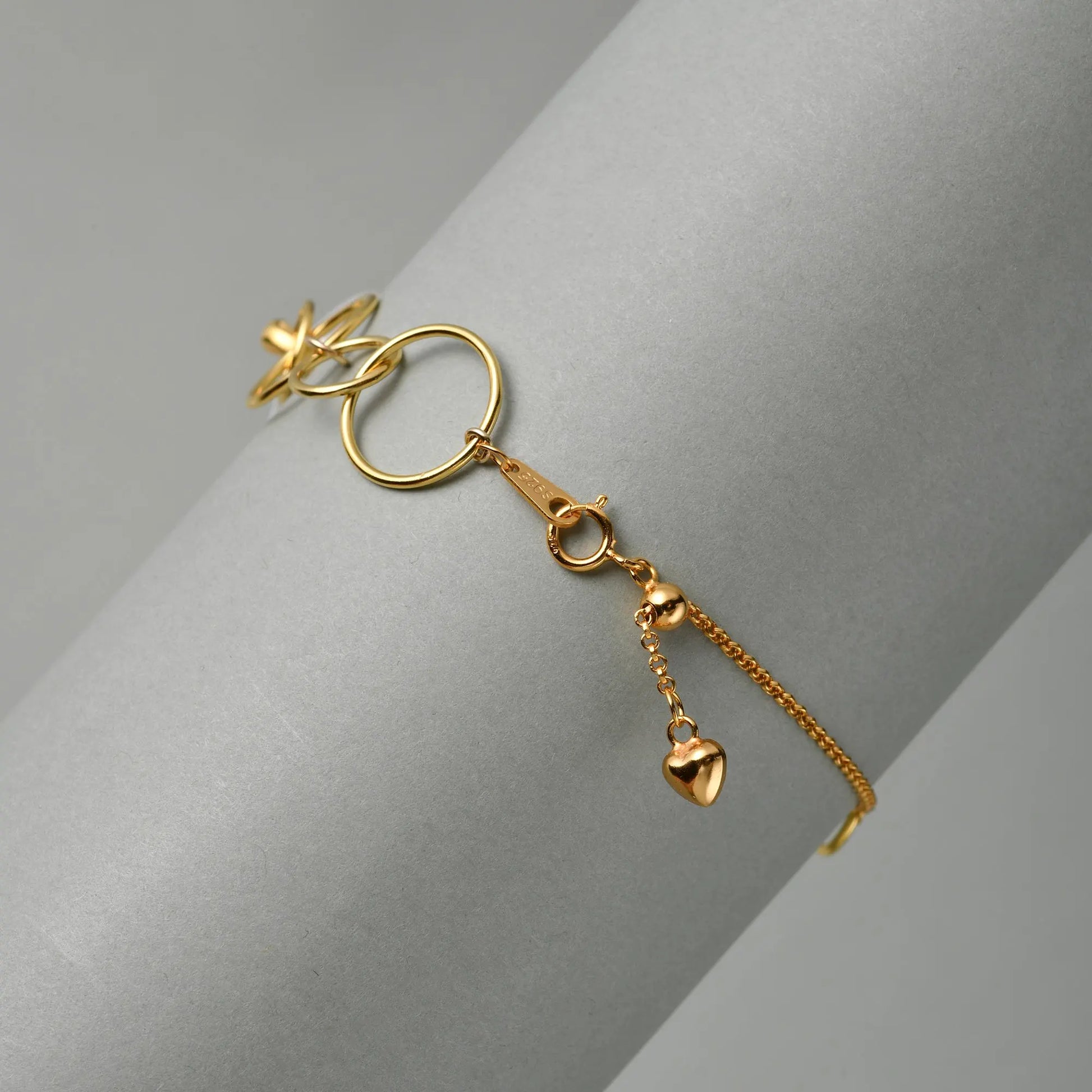 Minimal white studio shot showcasing adjustable 18k gold-plated extension chain and spring ring clasp of heart baroque pearl bracelet