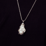 close-up-of-gray-baroque-pearl-with-silver-frame-setting-organic-curves