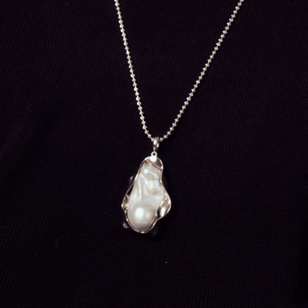 close-up-of-gray-baroque-pearl-with-silver-frame-setting-organic-curves