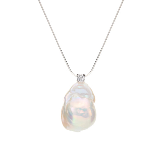 Overhead flat shot of thin sterling silver chain necklace, fitted with one oversized natural irregular rainbow luster white baroque pearl focal pendant 