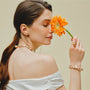 Soleil baroque pearl bracelet styled with white off-shoulder outfit