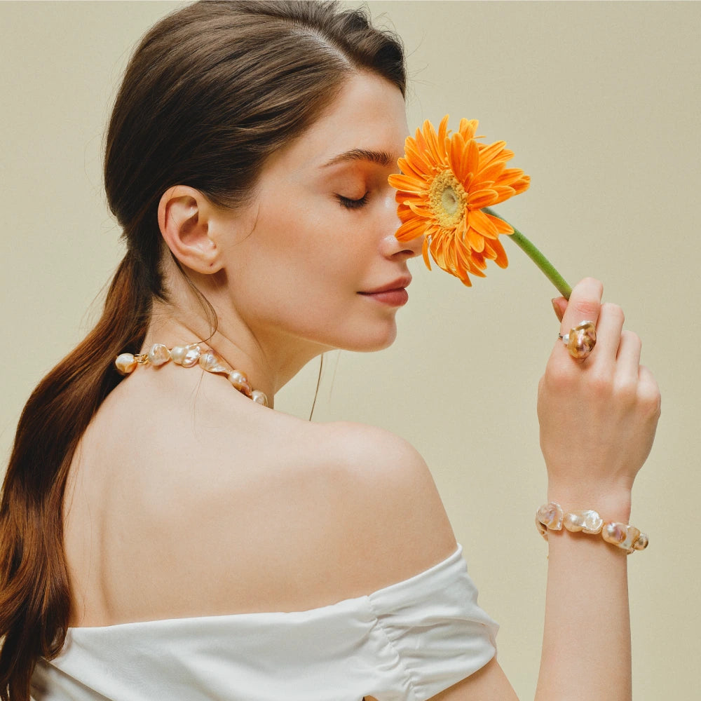 Soleil baroque pearl bracelet styled with white off-shoulder outfit