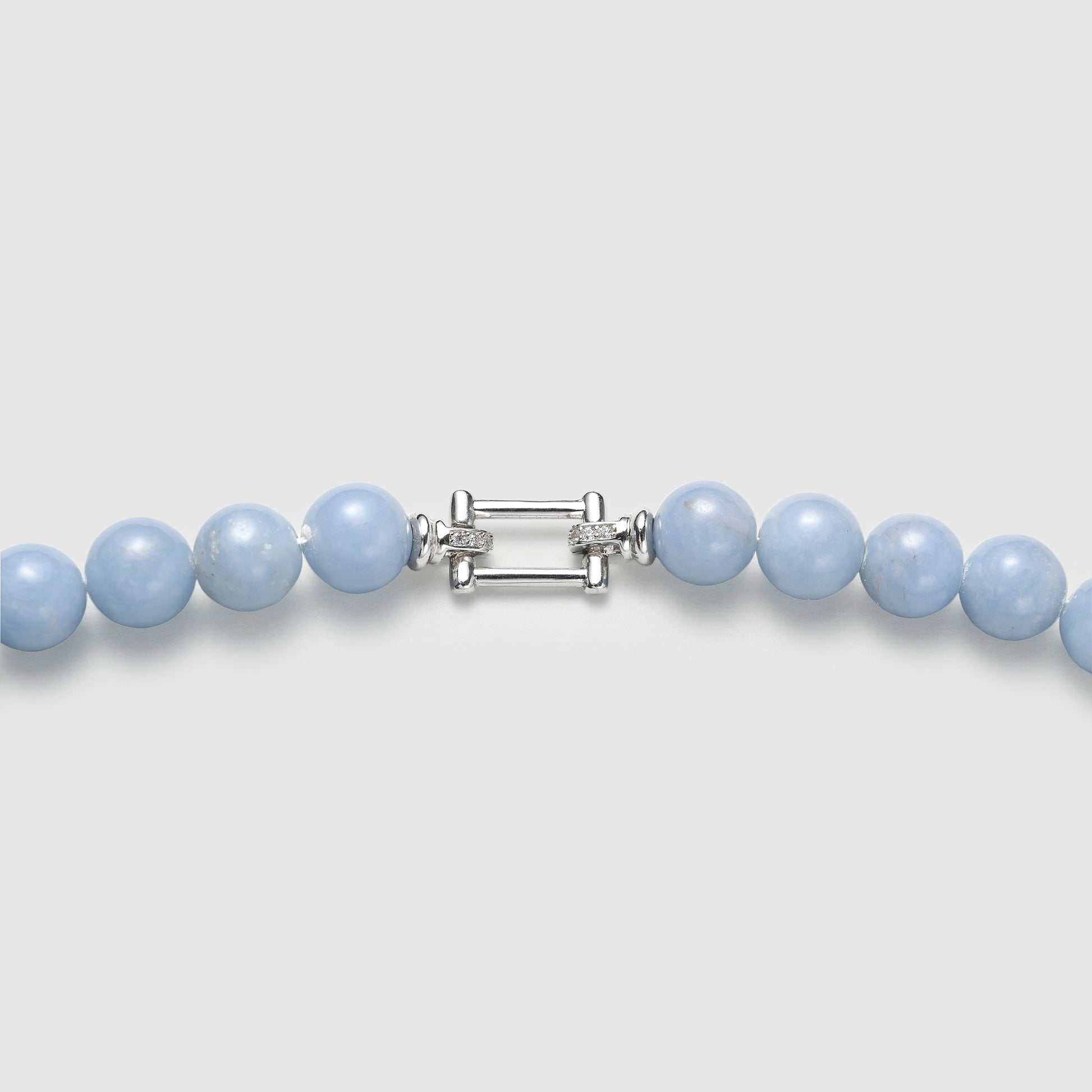 Close-up of silver clasp and light blue lapis lazuli bead details