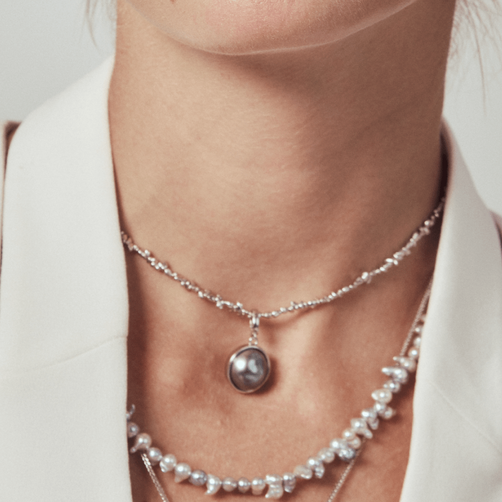 Model wearing the moody pearl necklace with white blazer