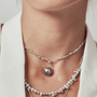 Model wearing the moody pearl necklace with white blazer