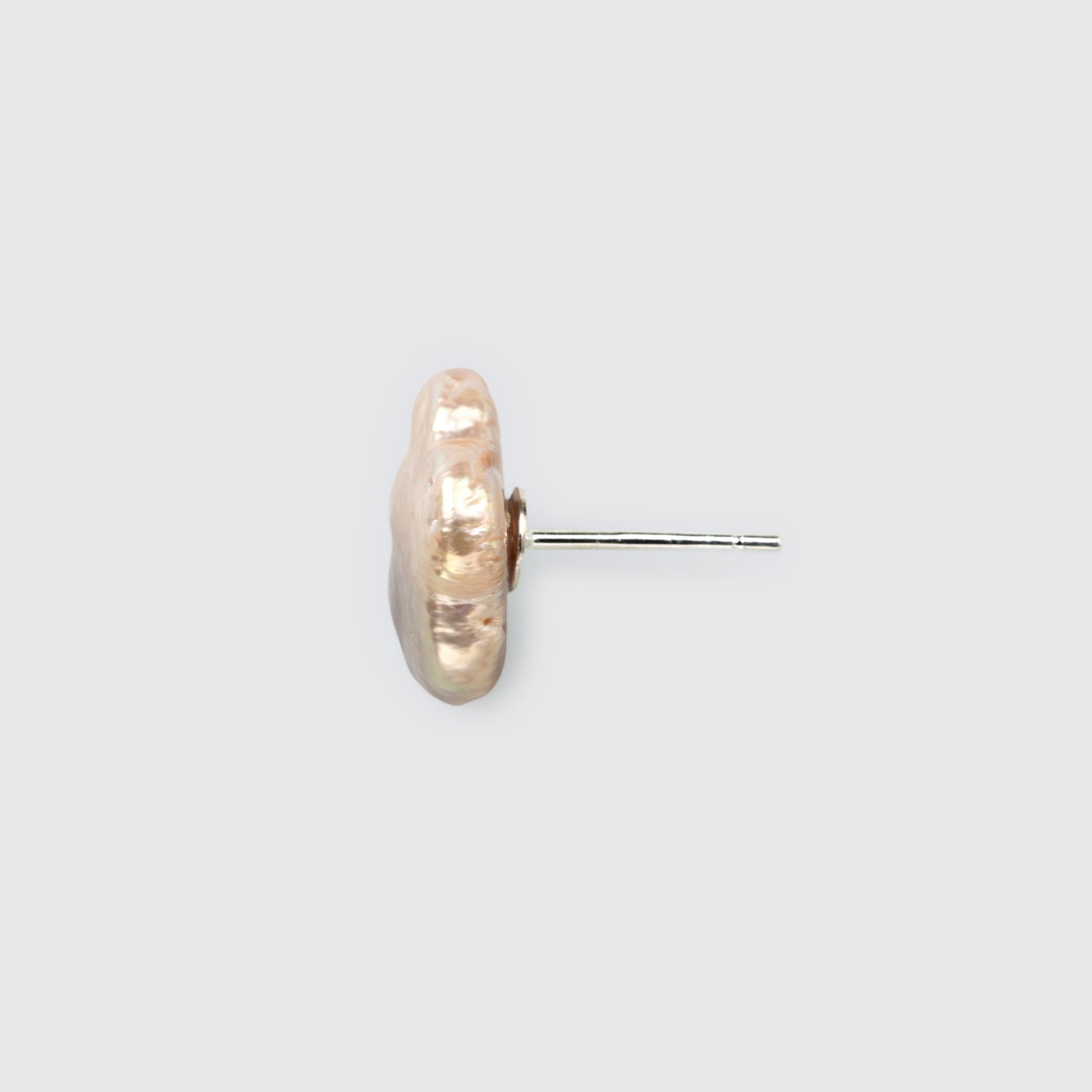 Unique natural baroque pearl studs with silver base closeup 