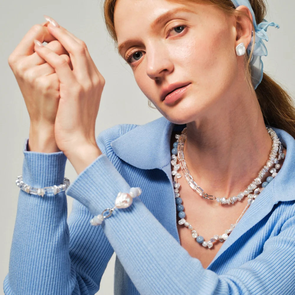 Woman wearing the Celeste keshi pearl and blue apatite necklace around her neck
