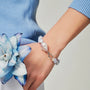 Woman wearing the Celeste pink pearl and blue chalcedony bracelet on her wrist