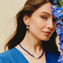 Woman wearing the Coral baroque pearl and lapis lazuli drop earrings on her ears
