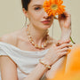 Woman wearing the Soleil golden baroque pearl jewelry set necklace bracelet and ring