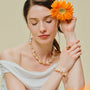 Woman wearing the Soleil golden baroque pearl necklace around her neck