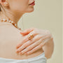 Woman wearing the Soleil golden baroque pearl open ring on her finger